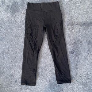 Cropped high waisted Lululemon black leggings with mesh detailing down the legs